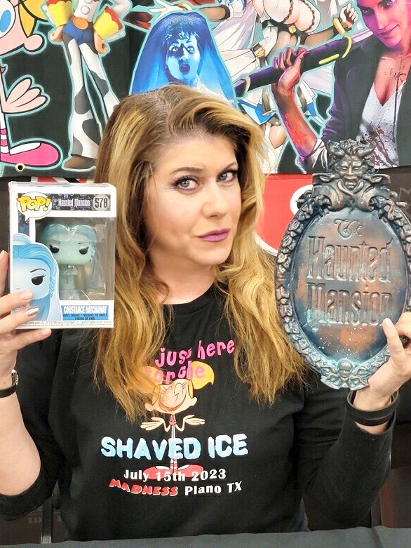 Kat Cressida The Haunted Mansion Bride at collectibles signing event with Disney Funko Pop and Disney merchandise