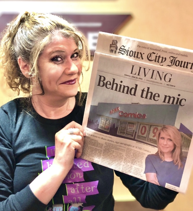 Kat Cressida Holding front page article Sioux City Journal for a fan signing event in Sioux City Iowa